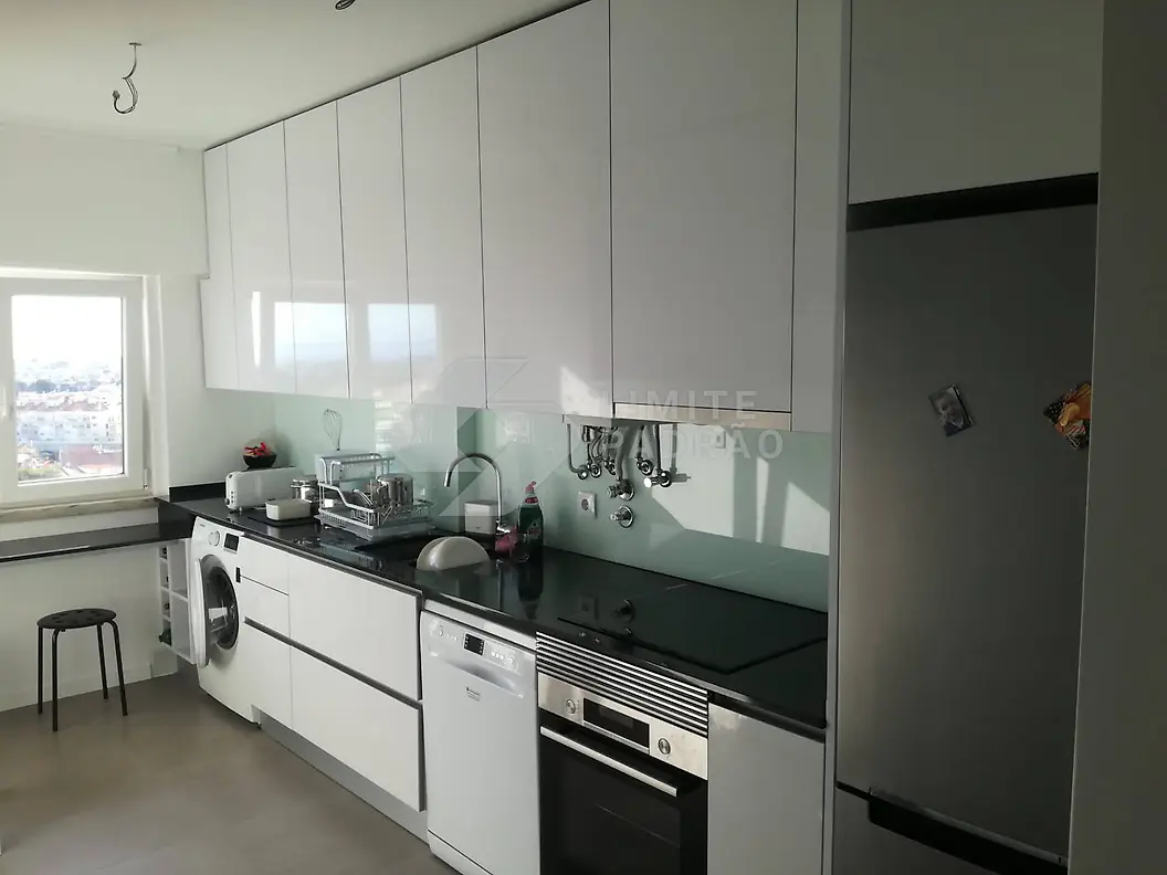 Cozinha: cozinha branca com bancada preta e vista
