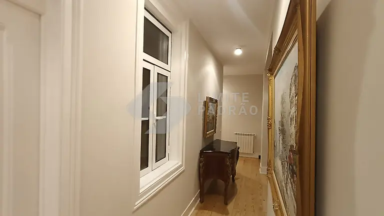 Corredor: corredor de apartamento clássico com janelas em madeira, radiador e quadro